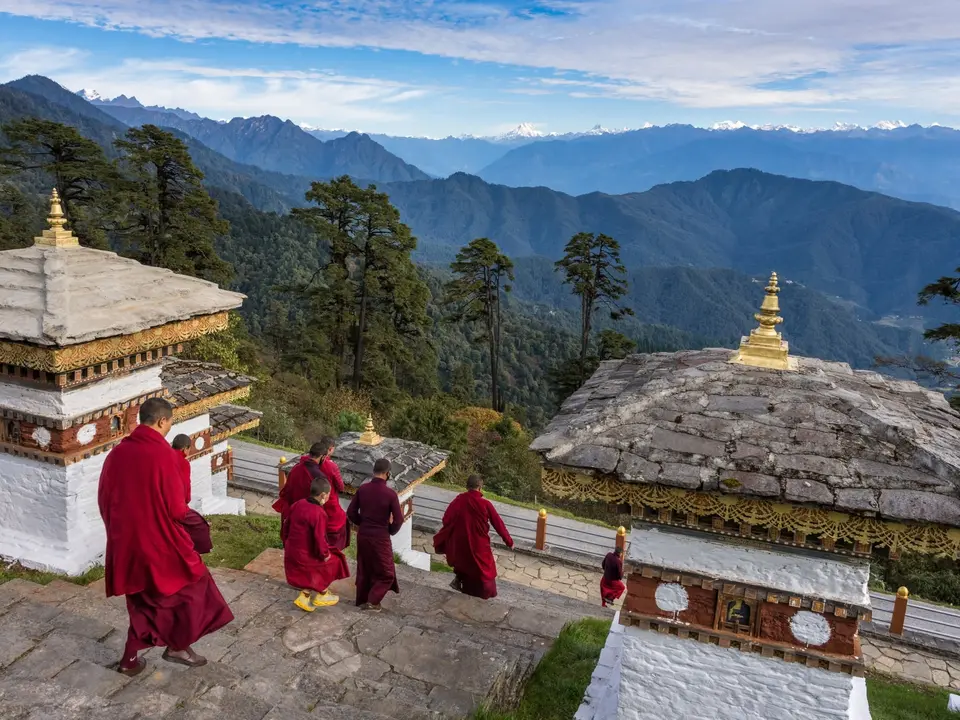 The 108 chortens at Dochula Pass, with the Himalayan range behind them